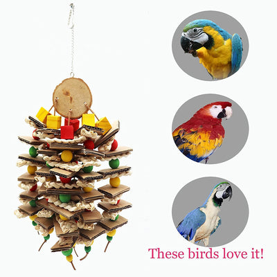 Parrot gnawing toy made of stacked cardboard, corn husks, and colorful wooden beads, with a parrot perched nearby. - Image 10