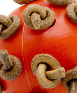 Red plastic interactive chewing ball with brown leather rope knots, next to a green parrot. - Image 10