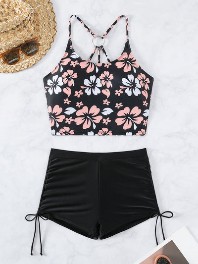 Women's two-piece swimsuit featuring a black halter crop top with pink and white floral print and solid black swim shorts. - Image 20