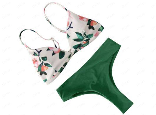 Navy blue bikini with a solid triangle top and high-waisted bottoms featuring a white and blue floral print. - Image 16