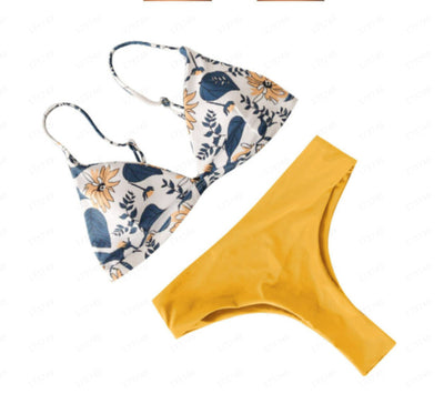 Navy blue bikini with a solid triangle top and high-waisted bottoms featuring a white and blue floral print. - Image 18