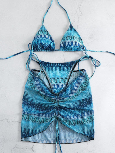 Three-piece printed swimsuit with a red and teal abstract pattern, featuring a halter bikini top, bottom, and mesh wrap skirt with drawstring. - Image 15