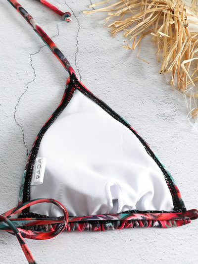 Three-piece printed swimsuit with a red and teal abstract pattern, featuring a halter bikini top, bottom, and mesh wrap skirt with drawstring. - Image 17