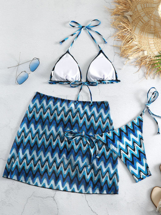 Three-piece printed swimsuit with a red and teal abstract pattern, featuring a halter bikini top, bottom, and mesh wrap skirt with drawstring. - Image 18