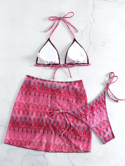 Three-piece printed swimsuit with a red and teal abstract pattern, featuring a halter bikini top, bottom, and mesh wrap skirt with drawstring. - Image 20