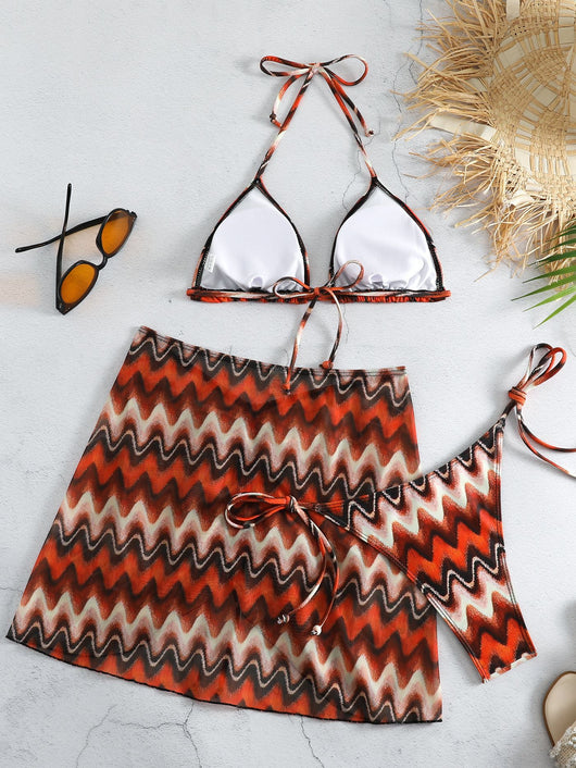 Three-piece printed swimsuit with a red and teal abstract pattern, featuring a halter bikini top, bottom, and mesh wrap skirt with drawstring. - Image 22