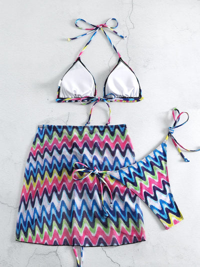 Three-piece printed swimsuit with a red and teal abstract pattern, featuring a halter bikini top, bottom, and mesh wrap skirt with drawstring. - Image 23