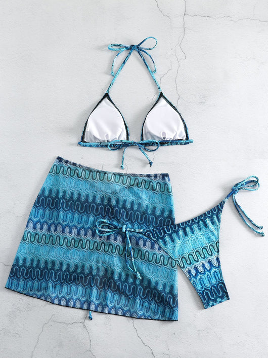 Three-piece printed swimsuit with a red and teal abstract pattern, featuring a halter bikini top, bottom, and mesh wrap skirt with drawstring. - Image 29