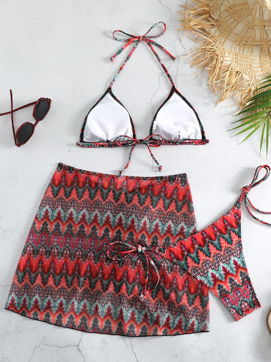 Three-piece printed swimsuit with a red and teal abstract pattern, featuring a halter bikini top, bottom, and mesh wrap skirt with drawstring. - Image 31