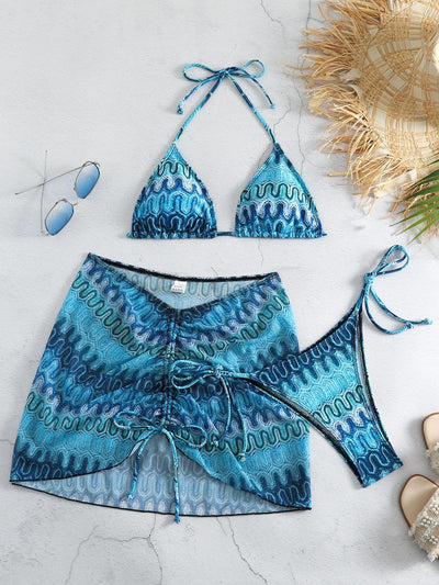 Three-piece printed swimsuit with a red and teal abstract pattern, featuring a halter bikini top, bottom, and mesh wrap skirt with drawstring. - Image 34
