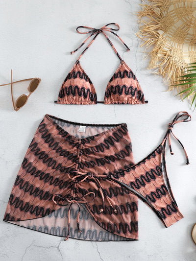 Three-piece printed swimsuit with a red and teal abstract pattern, featuring a halter bikini top, bottom, and mesh wrap skirt with drawstring. - Image 37