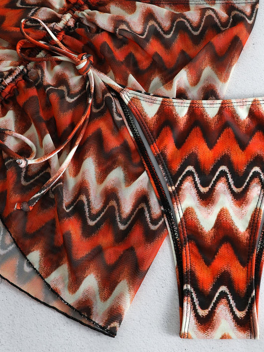 Three-piece printed swimsuit with a red and teal abstract pattern, featuring a halter bikini top, bottom, and mesh wrap skirt with drawstring. - Image 38