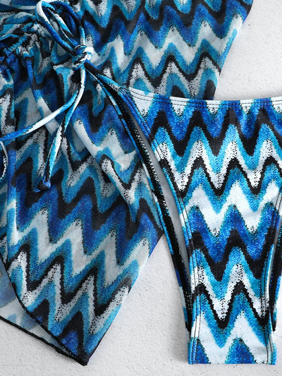 Three-piece printed swimsuit with a red and teal abstract pattern, featuring a halter bikini top, bottom, and mesh wrap skirt with drawstring. - Image 46