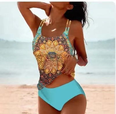 Woman wearing a red retro split high waist tankini swimsuit with an ornate mandala print top on a beach. - Image 22
