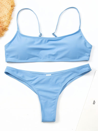 Women's casual orange textured bikini set with scoop neck top and high-cut bottoms against a stone wall. - Image 23