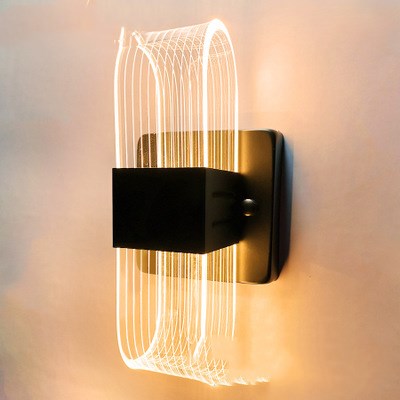 Modern simple LED wall lamp with a curved clear acrylic shade and a metallic base, emitting a warm light. - Image 11