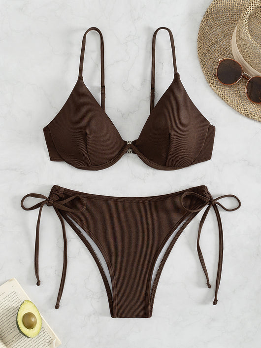 Black ribbed two-piece bikini with an underwire top and tie-side bottoms on a white marble surface. - Image 7