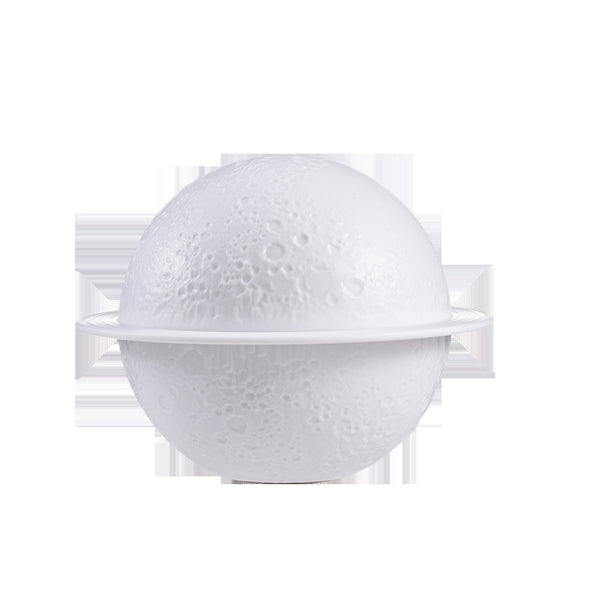 White moon-shaped humidifier with a textured surface resembling craters and a thin ring around its middle. - Image 10