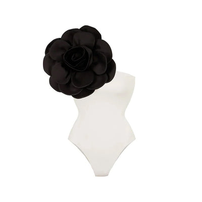 Black one-piece swimsuit with a large 3D flower on one shoulder and a geometric pattern on the bodice. - Image 13