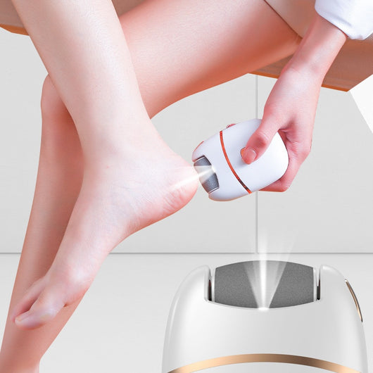 White and gold electric foot callus remover with a roller head, a replacement roller, cleaning brush, and USB cable. - Image 2