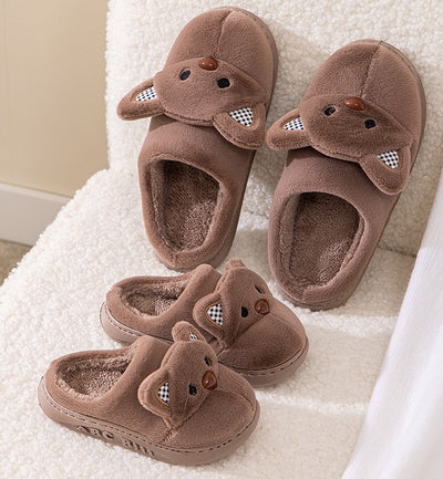 Pair of gray plush bear slippers with checkered ears and brown noses, held up against a soft background. - Image 5
