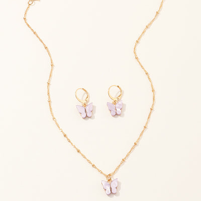 Blue resin butterfly necklace and earring set with gold-tone chains and findings, displayed on a light background. - Image 7