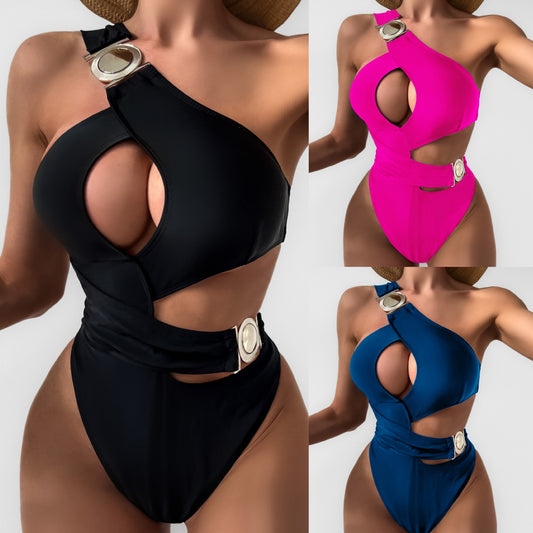 Hot pink one-piece swimsuit with an asymmetrical one-shoulder design, chest keyhole, side cutouts, and silver buckles.