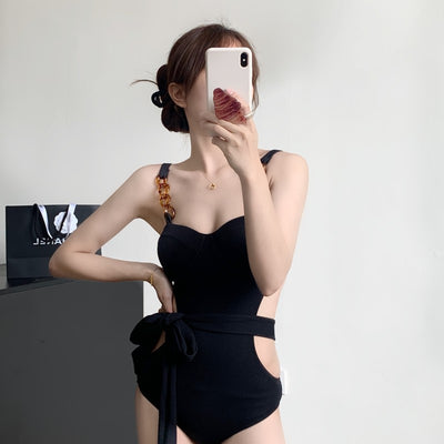 Black ribbed one-piece swimsuit with sweetheart neckline, chain-link shoulder strap, side cut-outs, and self-tie waist. - Image 6