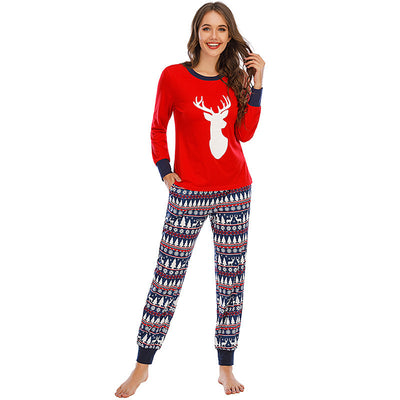 Family of five wearing matching red and navy blue Christmas pajamas with reindeer tops and fair isle pants. - Image 3