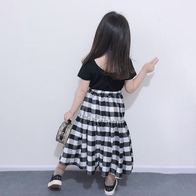 Matching black and white gingham two-piece outfits, one adult and one child size, with black short-sleeve tops and tiered skirts. - Image 3