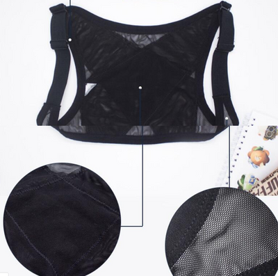 Woman wearing a black posture correction belt with criss-cross back design over a grey shirt, adjusting the strap. - Image 3