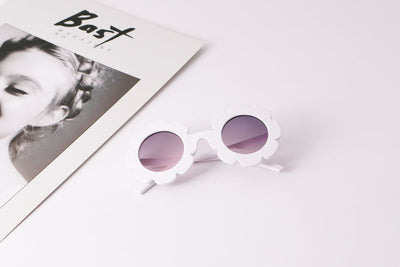Light blue flower-shaped sunglasses with dark lenses, featuring a playful design and plastic frame. - Image 10