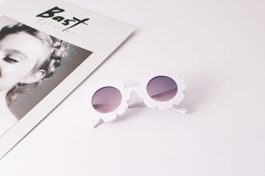 Light blue flower-shaped sunglasses with dark lenses, featuring a playful design and plastic frame. - Image 10