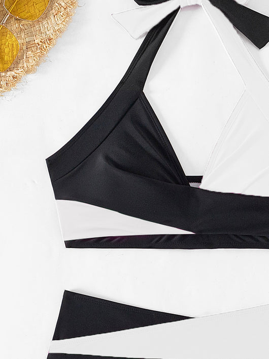 Black and white color-block halter bikini with high-waisted bottoms, modeled by a woman holding a straw hat. - Image 11