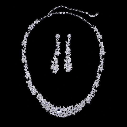 Silver-toned rhinestone necklace and matching dangle earrings set, featuring a sparkling floral cluster design.