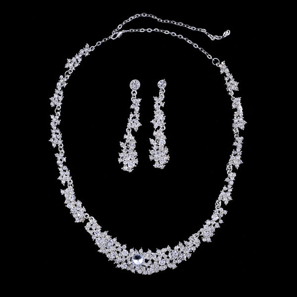 Silver-toned rhinestone necklace and matching dangle earrings set, featuring a sparkling floral cluster design.
