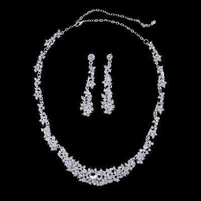 Silver-toned rhinestone necklace and matching dangle earrings set, featuring a sparkling floral cluster design.