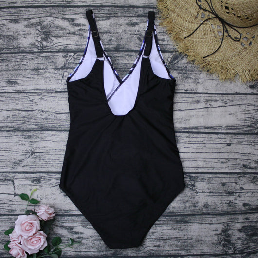 Plus size one-piece swimsuit with a blue, black, and white abstract print top and solid black bottom, featuring a wrap-front V-neck. - Image 4