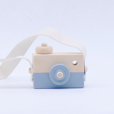 Two-tone wooden toy camera in natural wood and light blue with a cream fabric strap, for babies and kids. - Image 4
