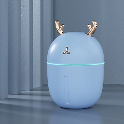 Pink deer-shaped mini humidifier with gold antlers and a glowing blue light band, on a pink background. - Image 10