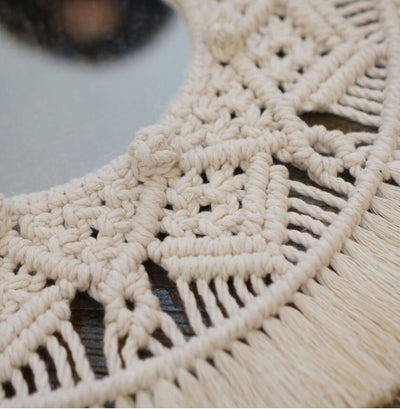 Circular mirror with a beige macrame fringe border, featuring intricate knotwork around the reflective surface. - Image 2