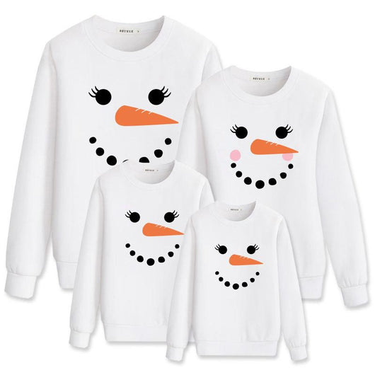 Family matching white long-sleeve crew neck tops with a cute snowman face print, featuring black eyes, an orange carrot nose, and a dotted smile. One adult top - Image 13