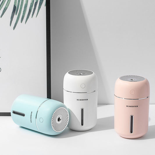 Pink USB car humidifier with a cylindrical design, silver accents, and a clear water level indicator. - Image 2