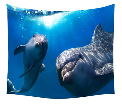 Polyester tapestry featuring two dolphins swimming in a bright blue underwater scene with sunlight filtering from above.