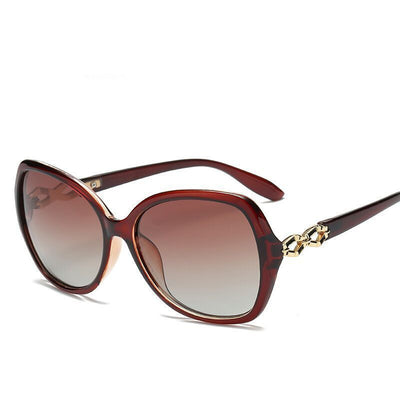Women's purple oversized polarized sunglasses with gradient lenses and gold chain link detail on the temples. - Image 3