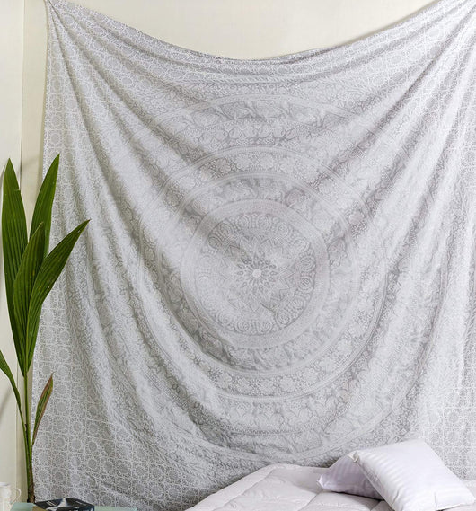 Gold and blue mandala tapestry with elephant and floral patterns, hung above a white quilted bed. - Image 4