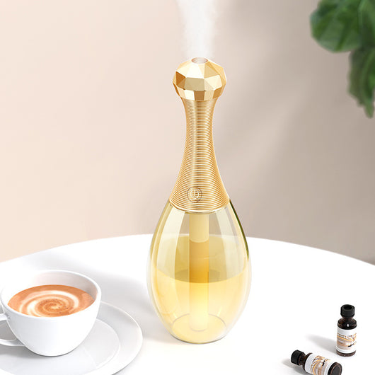 Mini silent portable humidifier shaped like a perfume bottle, with a clear body and a gold ribbed neck and faceted cap. - Image 10