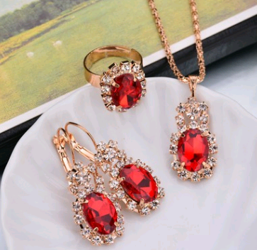 Rose gold-toned necklace, earrings, and ring set with large oval clear gemstones surrounded by smaller stones. - Image 8