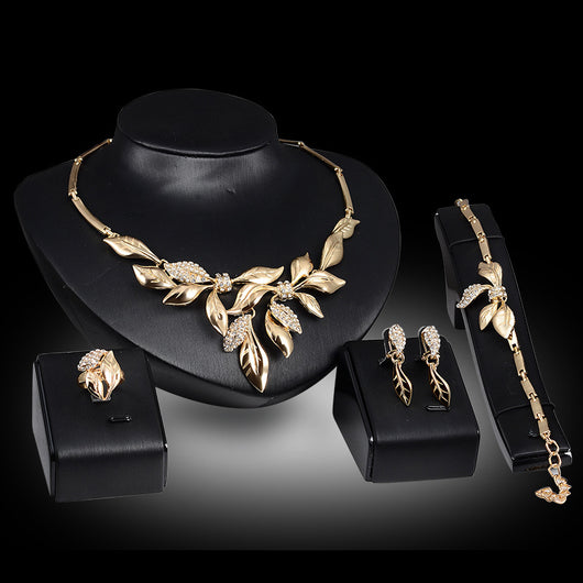 Gold-toned four-piece bridal wedding jewelry set with leaf design and clear rhinestones, including necklace, earrings, bracelet, and ring. - Image 2