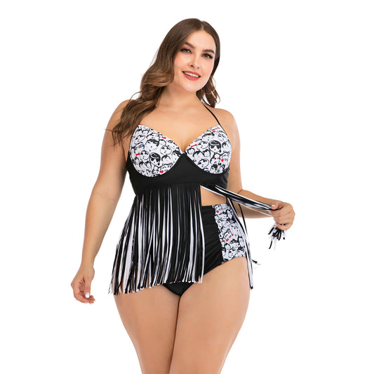 Plus size black and white two-piece swimsuit with cartoon face print, halter top, and high-waisted fringe bottoms.